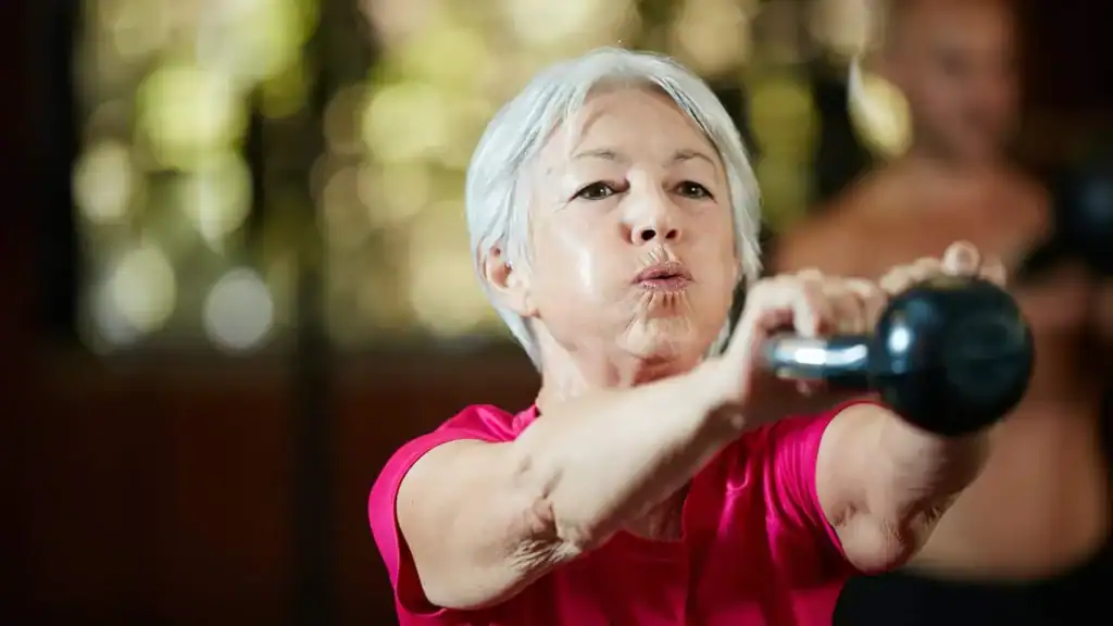 Toning Arms After 60: Empowering Womens Fitness Through Effective Weight Training 1 Older woman doing weight training Hamilton to help her strength and longevity